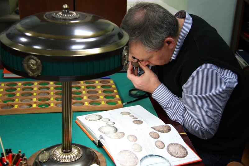 Coin Dealer Inspecting Rare Coins