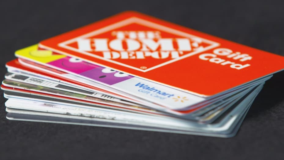 Stack of assorted retail gift cards including Home Depot and Walmart
