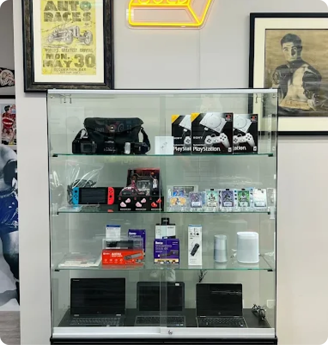 Brockton MA A glass display case with various electronics and gadgets