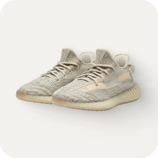 Brockton MA A pair of white sneakers with a thick sole, likely made of rubber or a similar material, is placed on a white