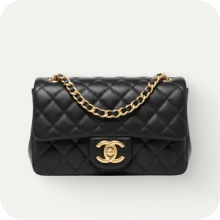 Brockton MA A black leather purse with a gold chain handle and a gold 'CC' logo on the front, set against a white background