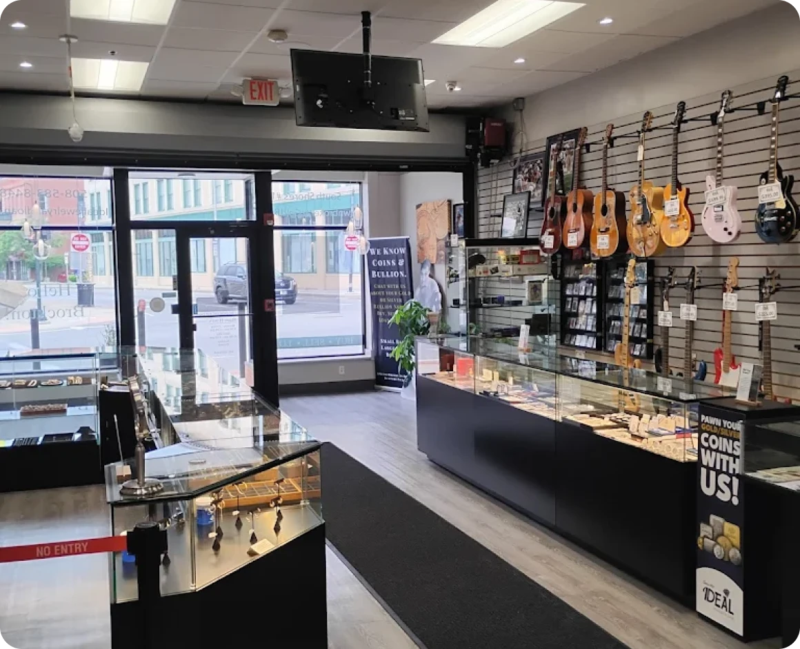 Brockton MA A store with a large window and a display of guitars on the wall