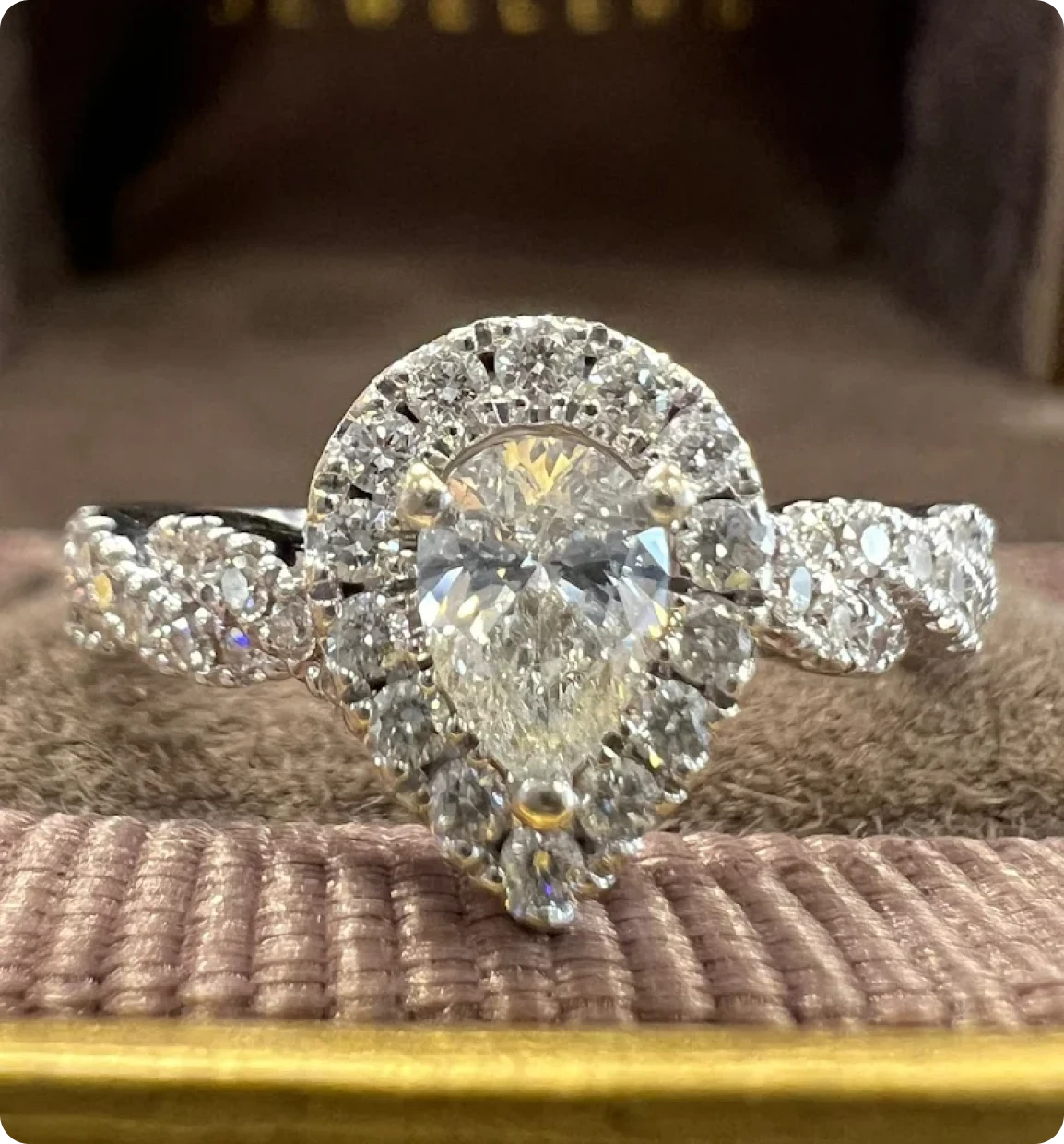 A beautiful gold ring with a diamond in the center, sitting on a velvet table in a pawn shop in Brockton MA, ready to be