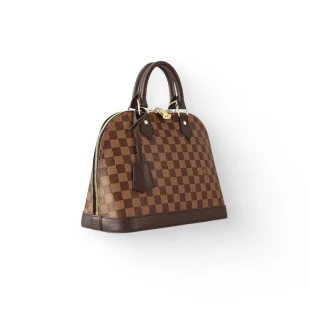 Brockton MA A brown and tan checkered purse with a gold clasp and a tassel on the front, against a white background