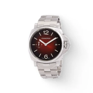 A silver watch with a black face and a red background, set against a white background, in the city of Brockton MA, where you