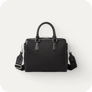 Brockton MA A black leather handbag with a silver buckle and a long strap