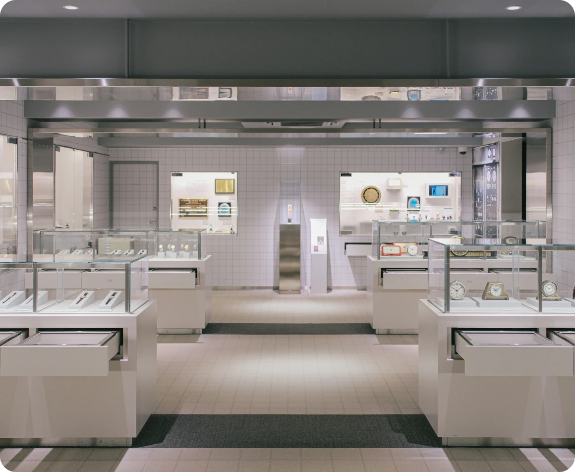 A modern, well-lit, and clean interior of a pawn shop in Brockton MA, with multiple white display cases and a variety of