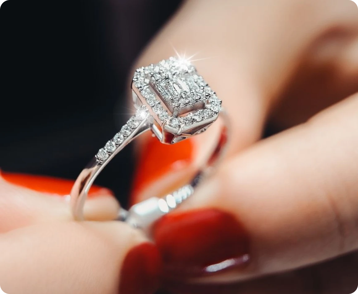 Brockton MA A woman's hand holding a diamond ring