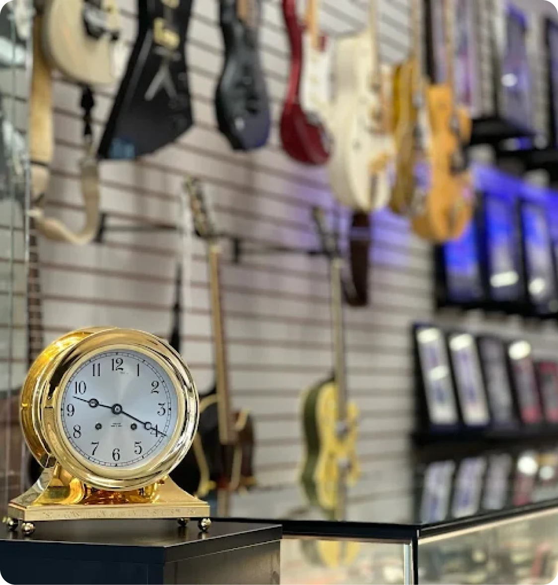 A gold clock sits on a table in a music store in Brockton MA